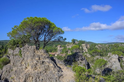 Rock labyrinth and view of the village of Mourèze, Département Hérault, France