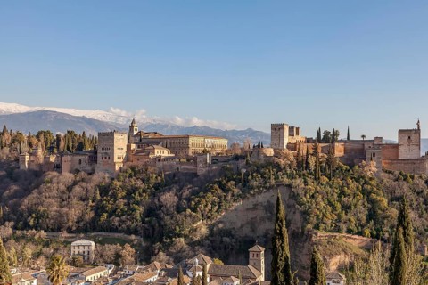 Alhambra on the Sabikah hill, Moorish city castle, Nasrid palaces, behind the snow-covered Sierra