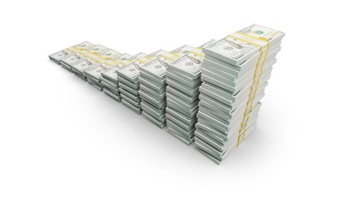 Rising stacks of money representing financial growth and wealth increase isolated on a white