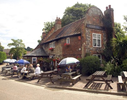 People sitting outside Adam and Eve pub, the oldest in Norwich, Norfolk, England, UK