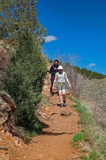 Idledale, Colorado - Hikers on the Bruin Bluff Trail in Lair o' the Bear Park. The park is part of