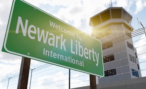 Newark liberty international airport green road sign in front of air traffic control tower