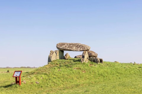 Passage grave on a hill with big boulders in a rural landscape with a clear blue sky Falköping,
