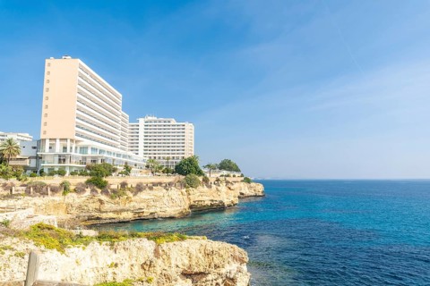 Breathtaking hotels perched on a cliff overlooking the turquoise mediterranean waters in cales de