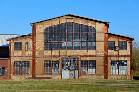 Abandoned factory with large windows and rusty structures, Ilseder Hütte, Ilsede, Peine district,