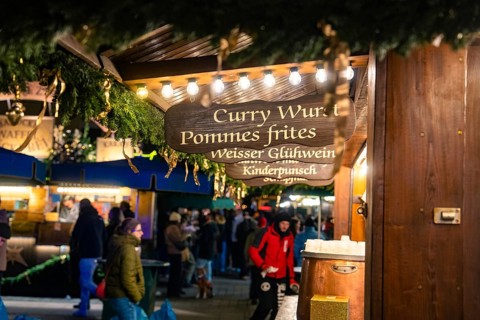 A food stall at a Christmas market with winter lighting, Christmas market Ludwigsburg, Germany