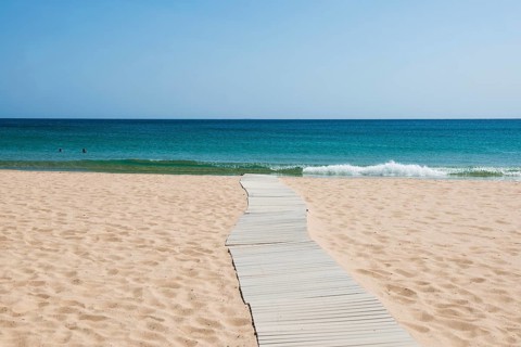 Sandy beach beach and blue sea, Spiaggia di Su Portu, Torre di Chia, Chia, south coast, Sardinia,