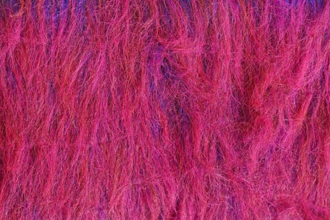 Close up of bright red and purple synthetic fake fur