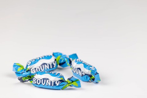 Three Bounty, small chocolate bars on a white background