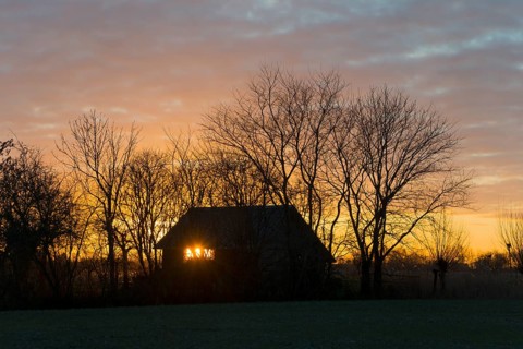 Sunset, sky burning, evening sun shining through a window of a house, house on the Dijkweg,