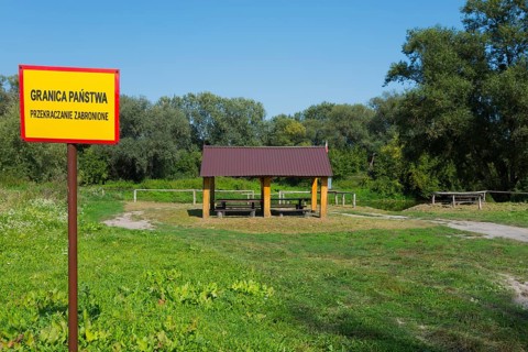 Border sign and wooden shelter in a green park with trees, border to Ukraine, Bereznica, Bereznica,