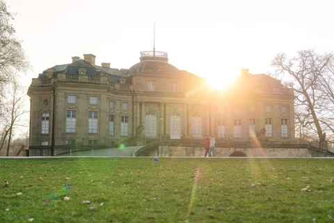 The historic palace at sunrise, surrounded by green lawns and trees, Domäne Monrepos, Ludwigsburg,