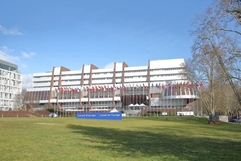 Palace of Europe with seat of the Council of Europe and inscription Council of Europe, EU flag, row