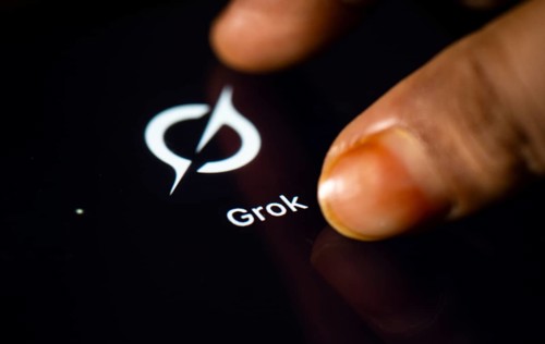 In this photo Illustration a person taps Grok AI application icon on a tablet device on 24 May 2025
