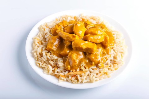 Rice with chicken curry sauce with cashew isolated on white background. close up