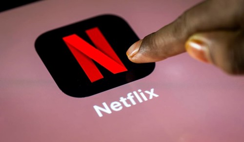 In this photo Illustration a person taps Netflix App icon on a tablet device on 24 May 2025 in New