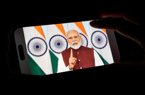 A person watches PM Narendra Modi's address to the nation after Operation Sindoor, on a mobile