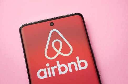 Airbnb logo is seen on a smartphone