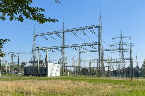 Substation with open-air switchgear for power distribution, in the background high electricity