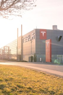Tesla production facility in the sunset with grey building and modern logo, Tesla, Holzgerlingen,