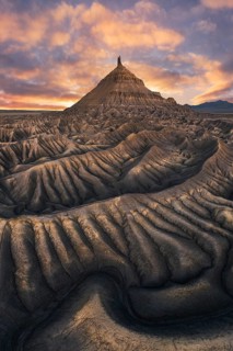 Majestic sunset illuminates the unique, rugged landscape of Factory Butte in Utah, showcasing
