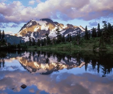 Twilight descends on Mount Shuksan in the North Cascades National Park as its snowy peak reflects