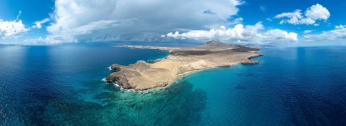 Headland and blue sea, coastal landscape, arid landscape of Los Ajaches Natural Park, aerial view,