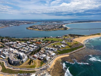 A breathtaking aerial view of Newcastle, New South Wales, showcasing the stunning coastline, urban