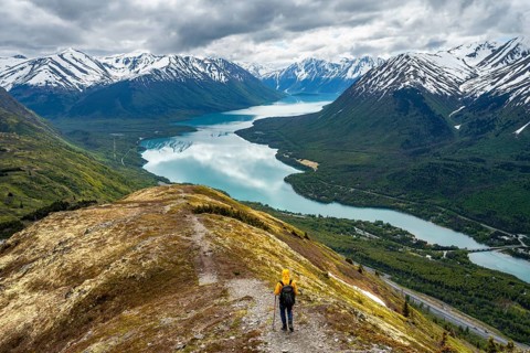 Climbers on a hiking trail on Slaughter Ridge, views of snowy mountains in spring and turquoise