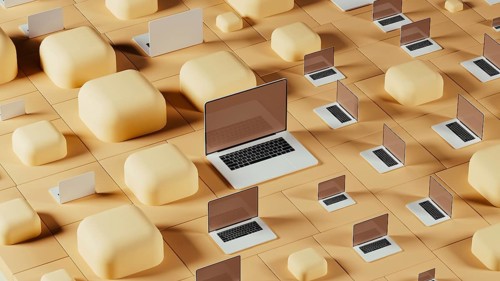Laptops are arranged against a backdrop of geometric shapes and tiles, creating a contemporary tech