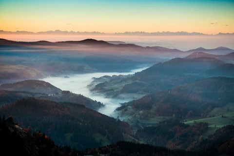 View from Belchen heading south of Wiesental and the Swiss Alps, morning atmosphere with fog in