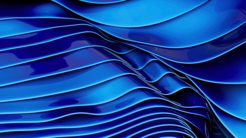 This image captures smooth blue silk waves creating a modern and elegant abstract design. The