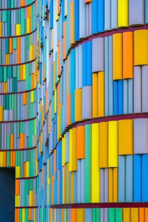 A striking image depicting the vivid, multicolored facade of a contemporary building, showcasing a