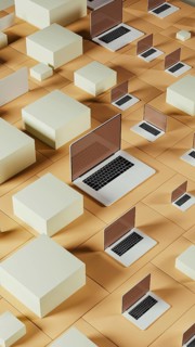 Multiple laptops rest on a geometric background made of tiles, showcasing a modern and abstract