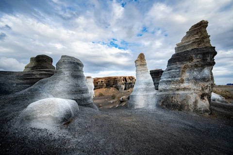Eroded rock formations, volcanic landscape with dramatic cloudy skies, Ciudad Estratificada or Los