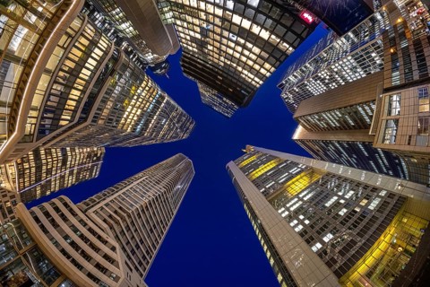 The glowing skyscrapers of Frankfurt's banking skyline rise into the blue evening sky, Frankfurt am