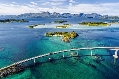Sommaroy Bridge connecting Kvaloya Island to Sommaroy Island, small islands, mountain range in the