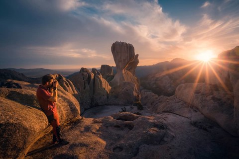 A photographer captures the stunning sunset over Pedriza's iconic rock formations in the Sierra de