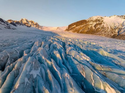 The stunning beauty of the Skaftafell Glacier during winter. The sunlight accentuates the rugged