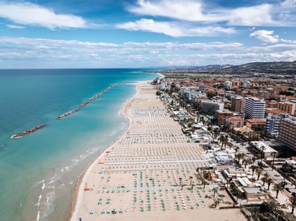 Stunning aerial shot of San Benedetto, Italy, showcasing its expansive sandy beaches, vibrant