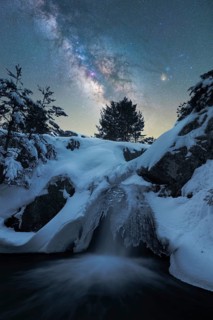 Captivating night scene depicting the Milky Way over a snow-laden landscape in Iceland A frozen