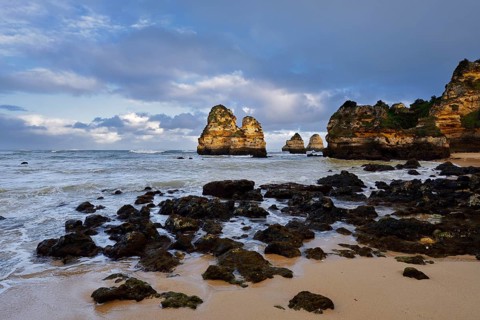 Rock formations on the coast in the evening light, Praia do Camilo, Lagos, Algarve, Portugal