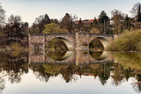 Stone bridge reflected in the calm water with surrounding nature, The historic Bartenwetz stone