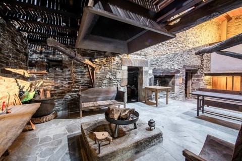 Traditional Lugo, Spain country house featuring rustic stone walls and a large open hearth in a