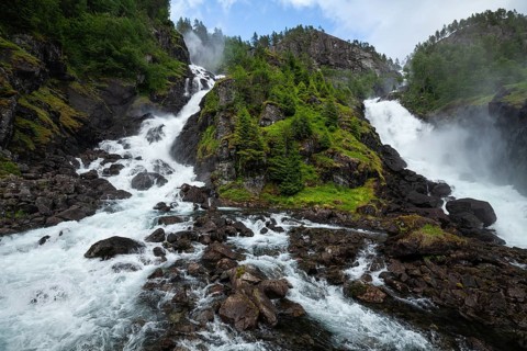 Summer day visiting Låtefossen falls near Odda, flowing water and green valley, Vestland, Norway