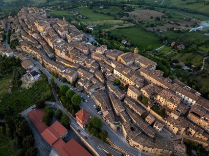 Aerial view of Treia, Italy, highlighting its remarkable medieval architecture nestled amid lush