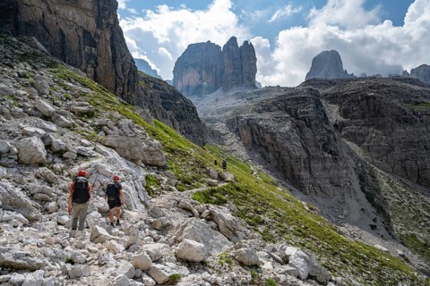 Two mountaineers in front of picturesque mountain landscape with rocky peaks, Via Ferrata SOSAT via