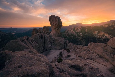 Captivating sunset view over the dramatic rock formations in Pedriza, Madrid. The warm hues paint