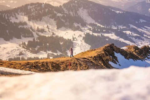 Person enjoying the view of an impressive, snow-covered mountain landscape, Hochgrat Mountains,