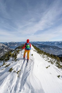Ski tourer at the summit of Simetsberg, mountain panorama, Estergebirge, Bavarian Prealps, Bavaria